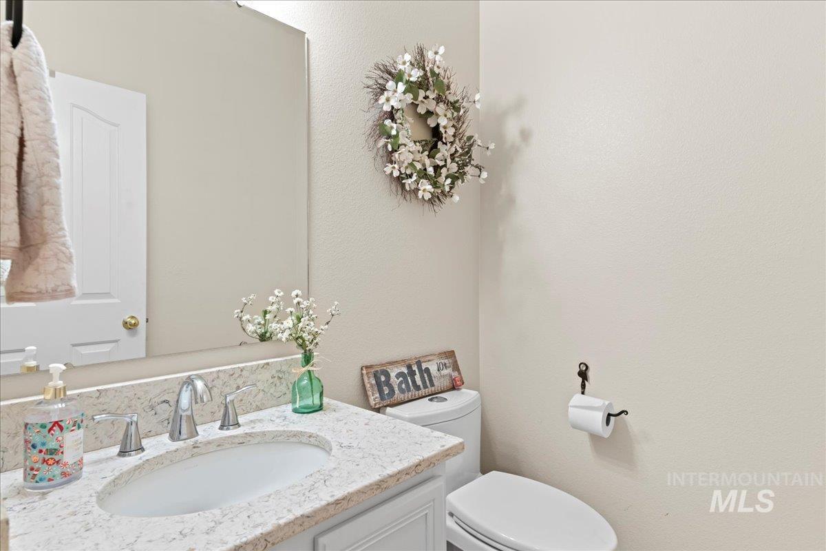 6326 North Talcrest Place Boise, ID 83713 - Photo 17 of 34 Half bathroom with vanity and a textured wall