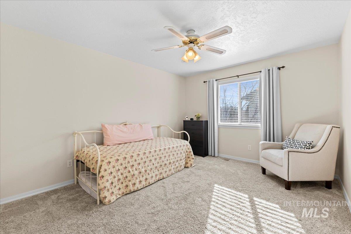 6326 North Talcrest Place Boise, ID 83713 - Photo 24 of 34 Bedroom with light carpet, a ceiling fan, and a textured ceiling