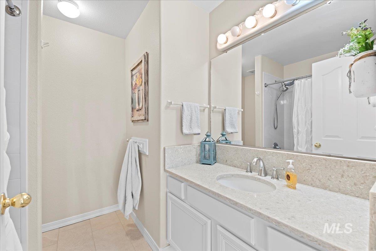 6326 North Talcrest Place Boise, ID 83713 - Photo 26 of 34 Full bathroom featuring vanity, a shower with shower curtain, and light tile patterned flooring