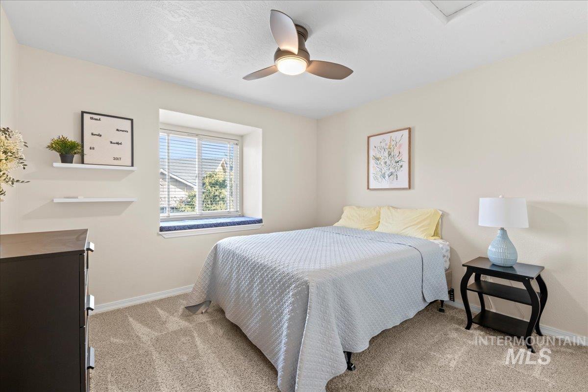 6326 North Talcrest Place Boise, ID 83713 - Photo 27 of 34 Bedroom with ceiling fan and light colored carpet
