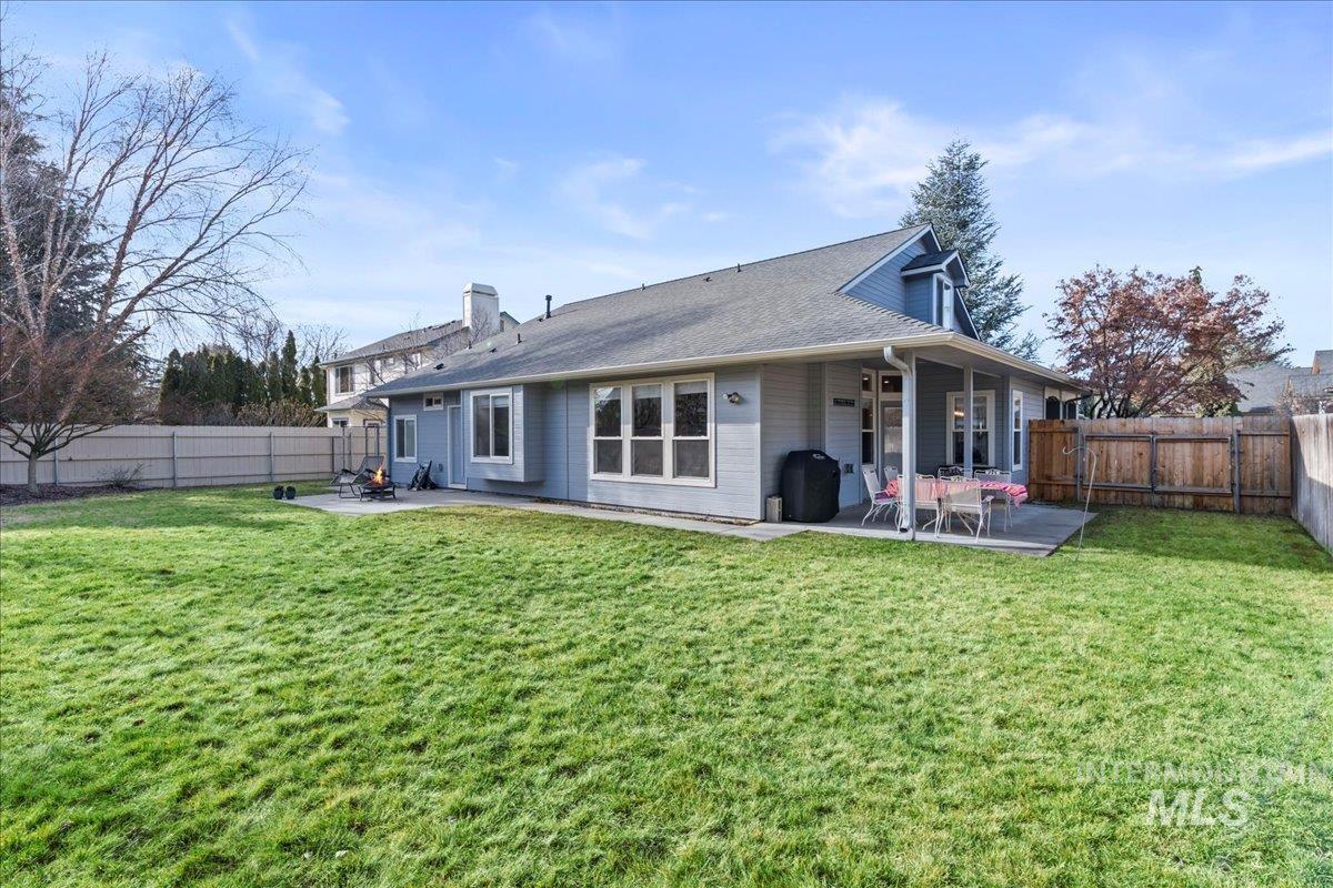 6326 North Talcrest Place Boise, ID 83713 - Photo 30 of 34 Rear view of property with a patio, a fenced backyard, and a chimney