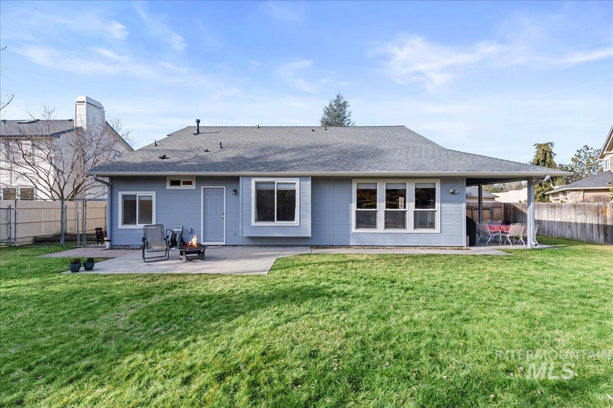 6326 North Talcrest Place Boise, ID 83713 - Photo 31 of 34 Back of property featuring a patio area, a fenced backyard, and a shingled roof