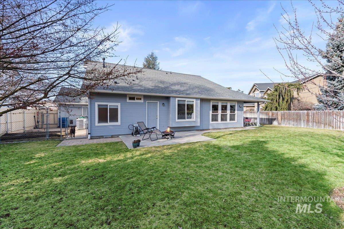 6326 North Talcrest Place Boise, ID 83713 - Photo 32 of 34 Back of property featuring a fenced backyard, a patio, and a shingled roof