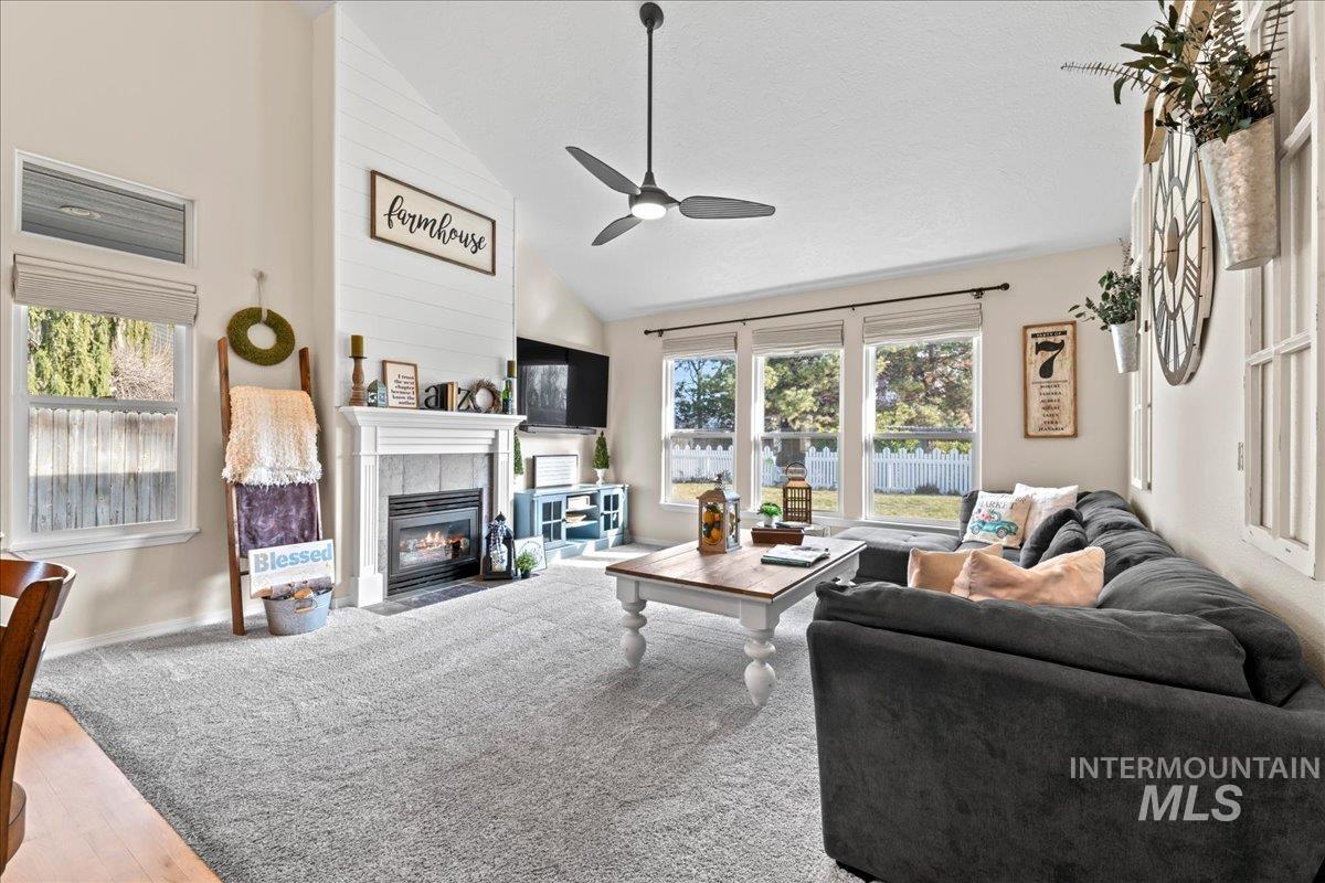 6326 North Talcrest Place Boise, ID 83713 - Photo 6 of 34 Living room with a tiled fireplace, vaulted ceiling, ceiling fan, and wood finished floors