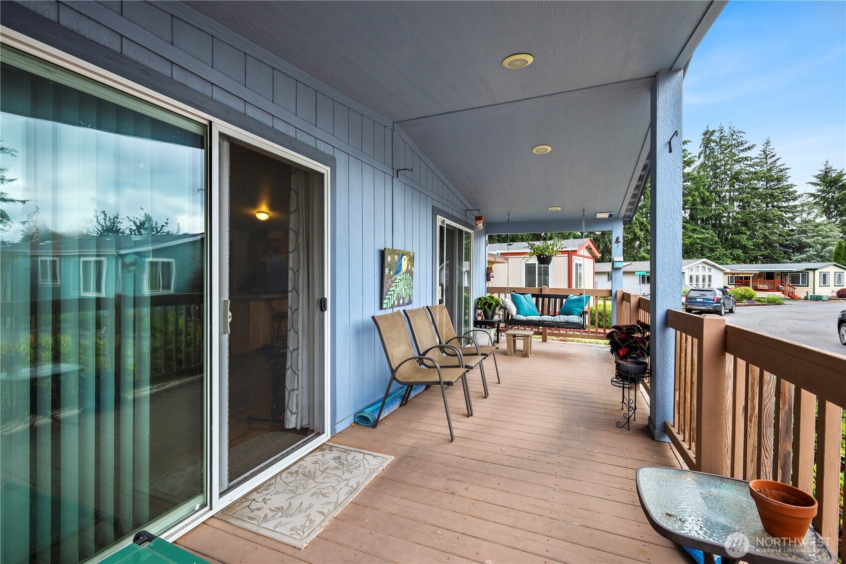 19206 99th Avenue East, Unit 48 Graham, WA 98338 - Photo 15 of 28 a view of a porch with chairs and backyard