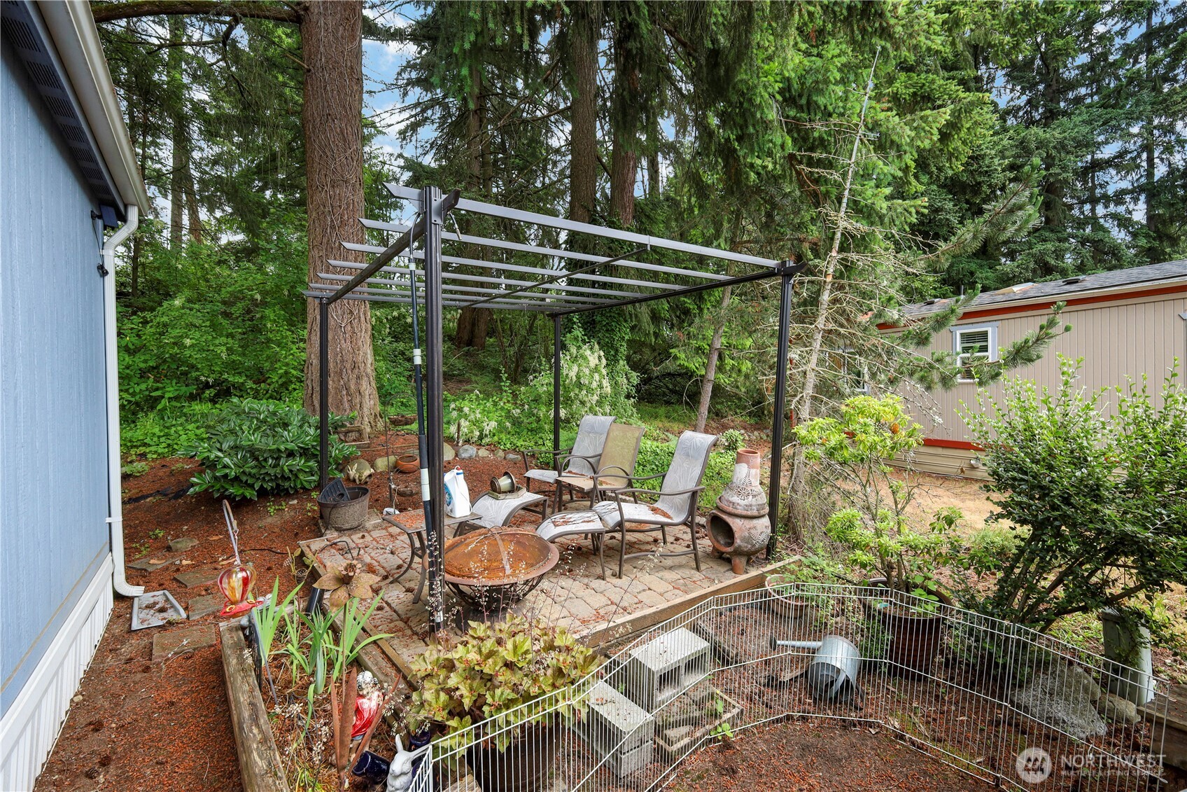 19206 99th Avenue East, Unit 48 Graham, WA 98338 - Photo 18 of 28 a view of backyard with plants and outdoor seating