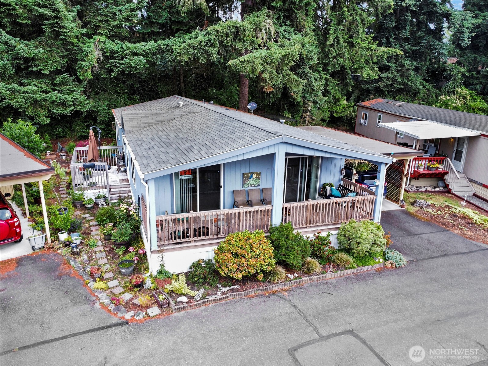 19206 99th Avenue East, Unit 48 Graham, WA 98338 - Photo 23 of 28 a front view of a house with a garden