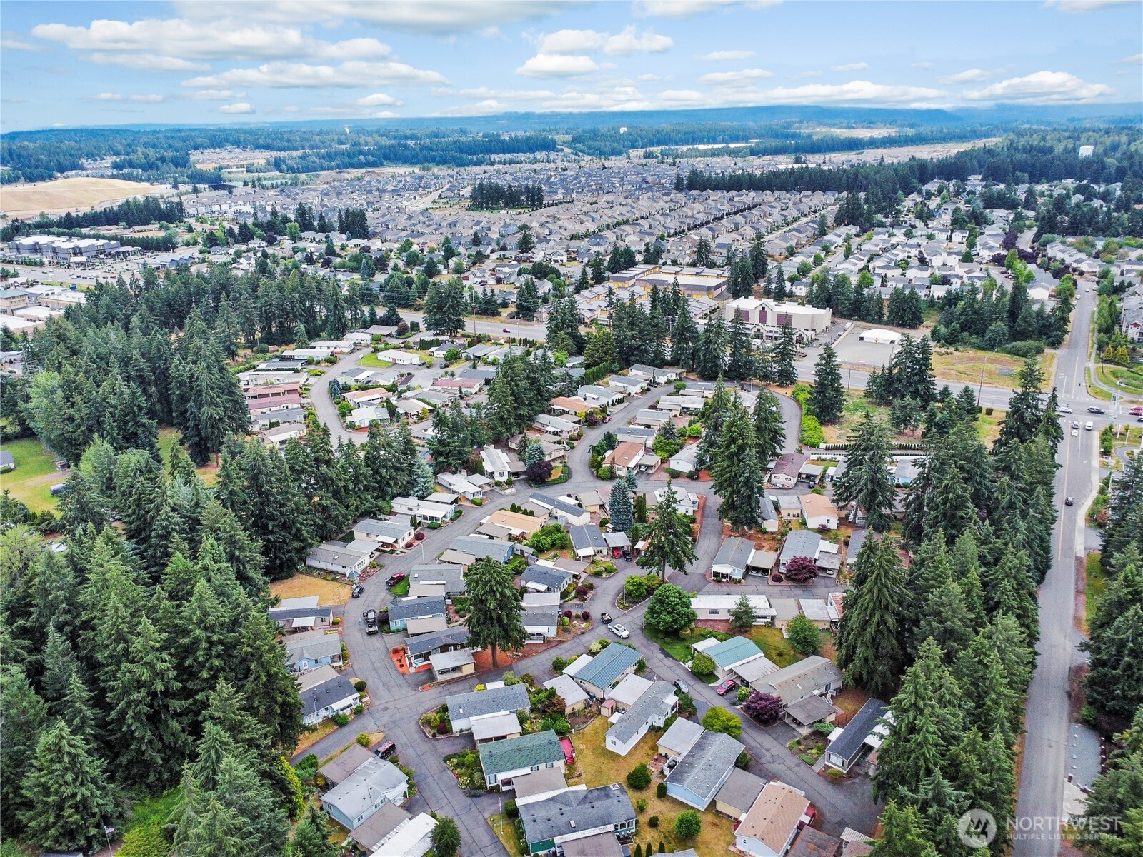 19206 99th Avenue East, Unit 48 Graham, WA 98338 - Photo 25 of 28 an aerial view of a city with lots of residential buildings