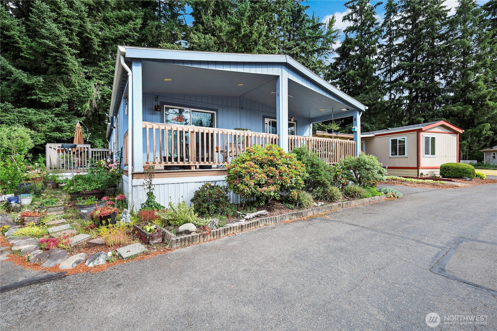 19206 99th Avenue East, Unit 48 Graham, WA 98338 - Photo 26 of 28 front view of house with a yard and table and chairs