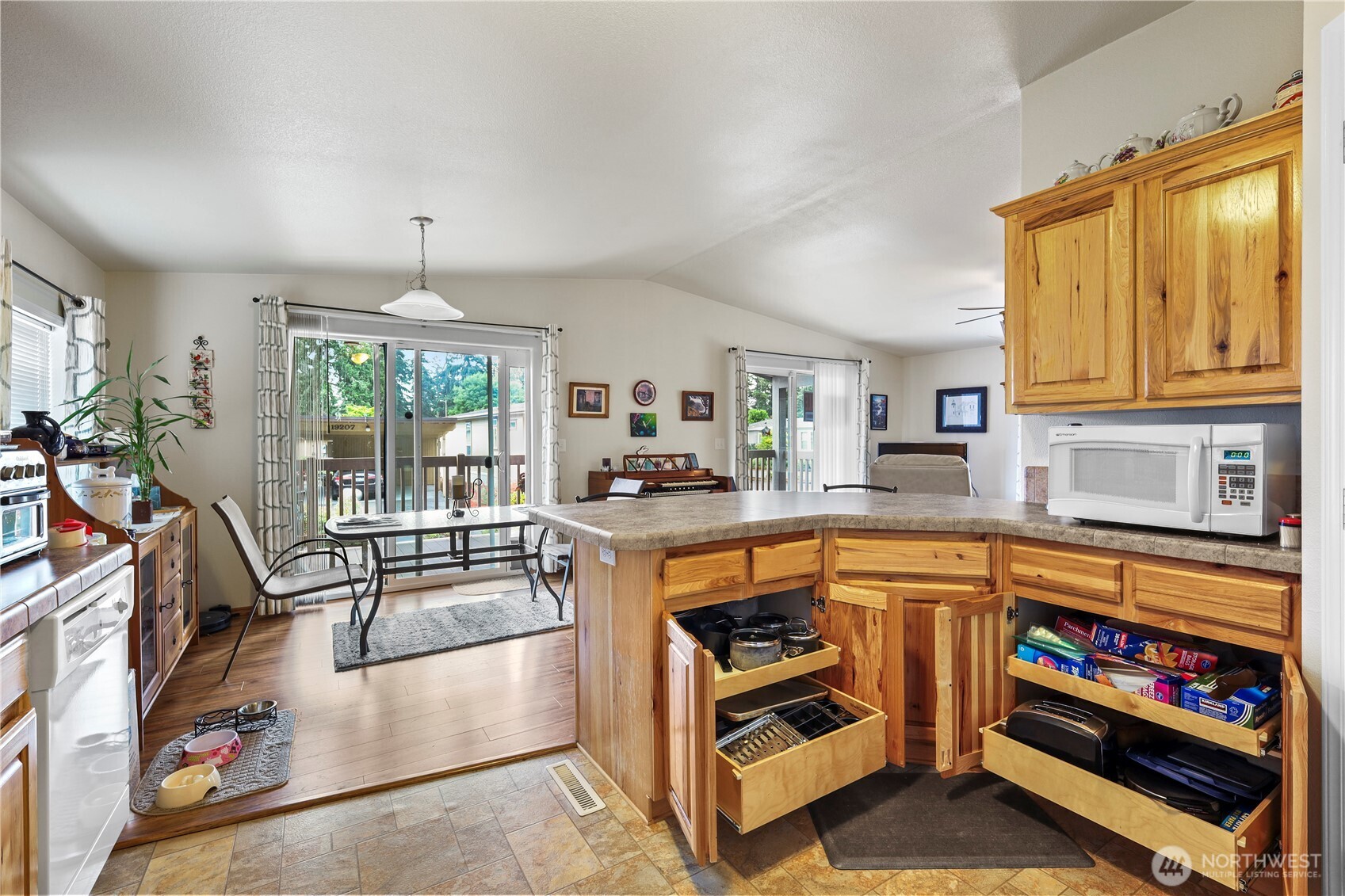 19206 99th Avenue East, Unit 48 Graham, WA 98338 - Photo 4 of 28 a kitchen with stainless steel appliances granite countertop a stove and a sink with cabinets