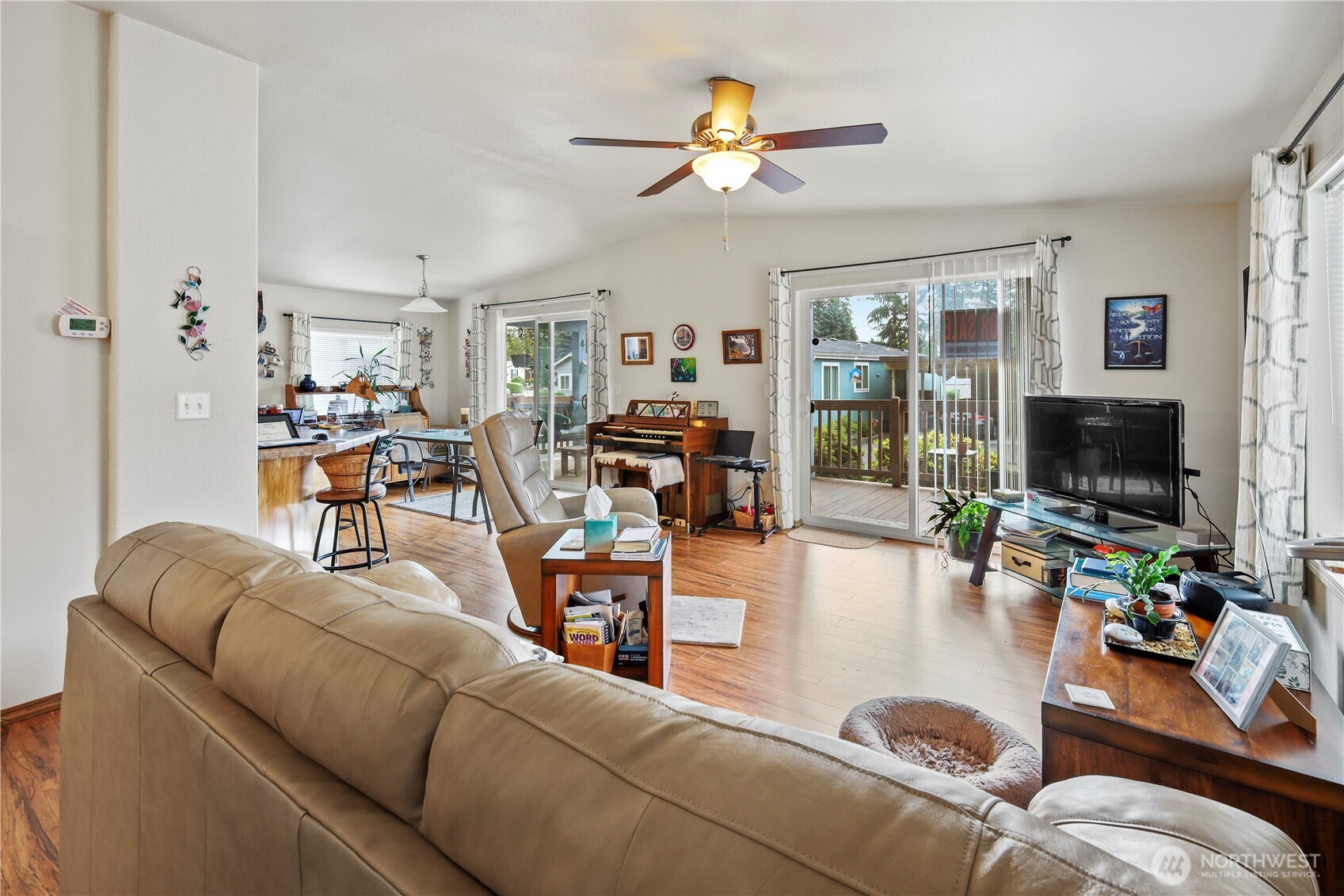 19206 99th Avenue East, Unit 48 Graham, WA 98338 - Photo 5 of 28 a living room with furniture and a flat screen tv