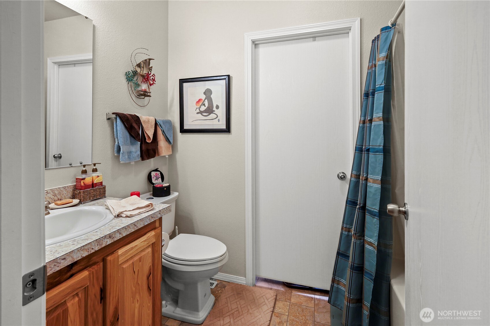 19206 99th Avenue East, Unit 48 Graham, WA 98338 - Photo 7 of 28 a white toilet sitting next to a bathroom sink