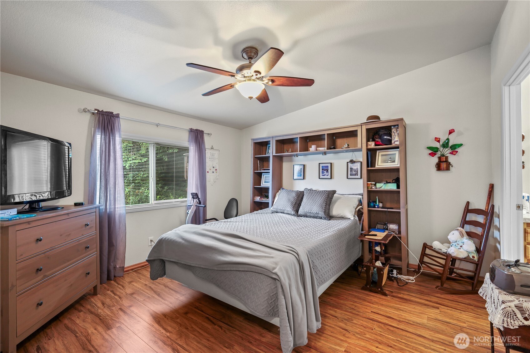 19206 99th Avenue East, Unit 48 Graham, WA 98338 - Photo 10 of 28 a bedroom with a large bed and a flat screen tv