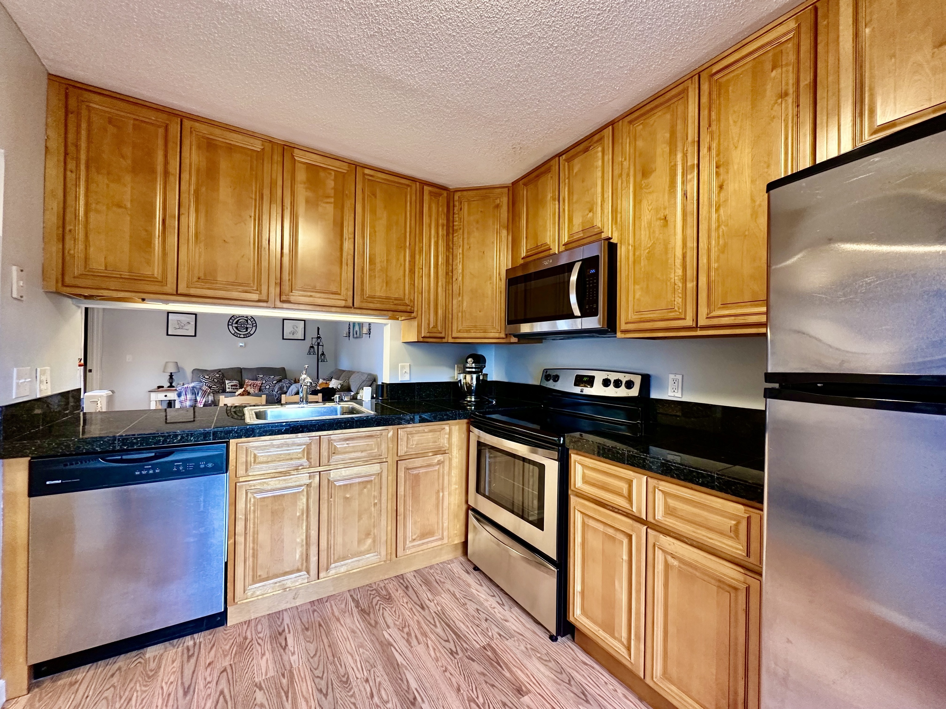 30 Orange Road, Unit 30 Middletown, CT 06457 - Photo 7 of 28 a kitchen with granite countertop wooden cabinets and a stove top oven