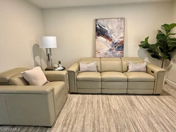 a living room with furniture and a lamp