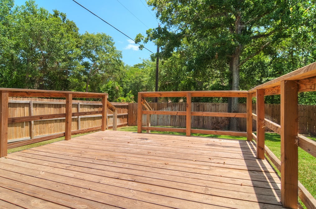 4454 Reveille Road College Station, TX 77845 - Photo 11 of 13 a view of house with deck outdoor seating and trees in the background