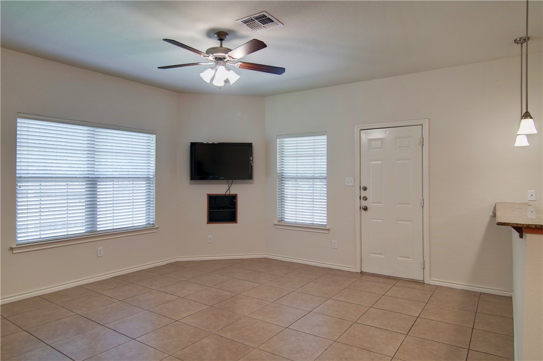 4454 Reveille Road College Station, TX 77845 - Photo 3 of 13 a view of an empty room with a window and a kitchen