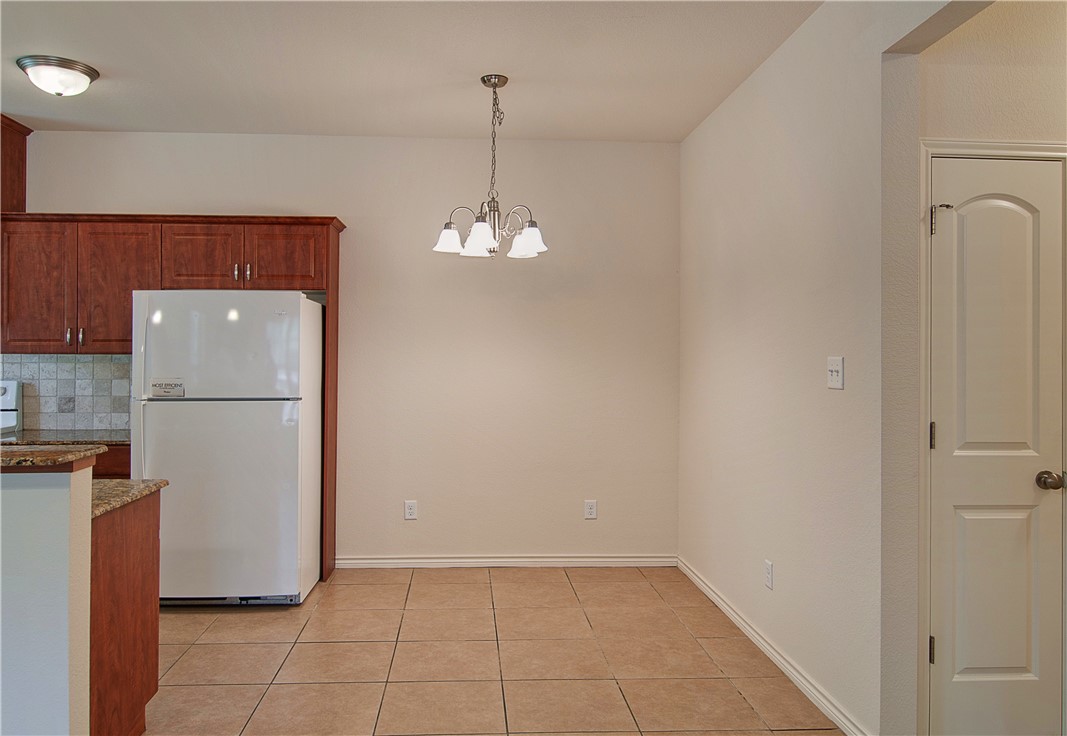 4454 Reveille Road College Station, TX 77845 - Photo 5 of 13 a view of a kitchen with refrigerator and wooden floor