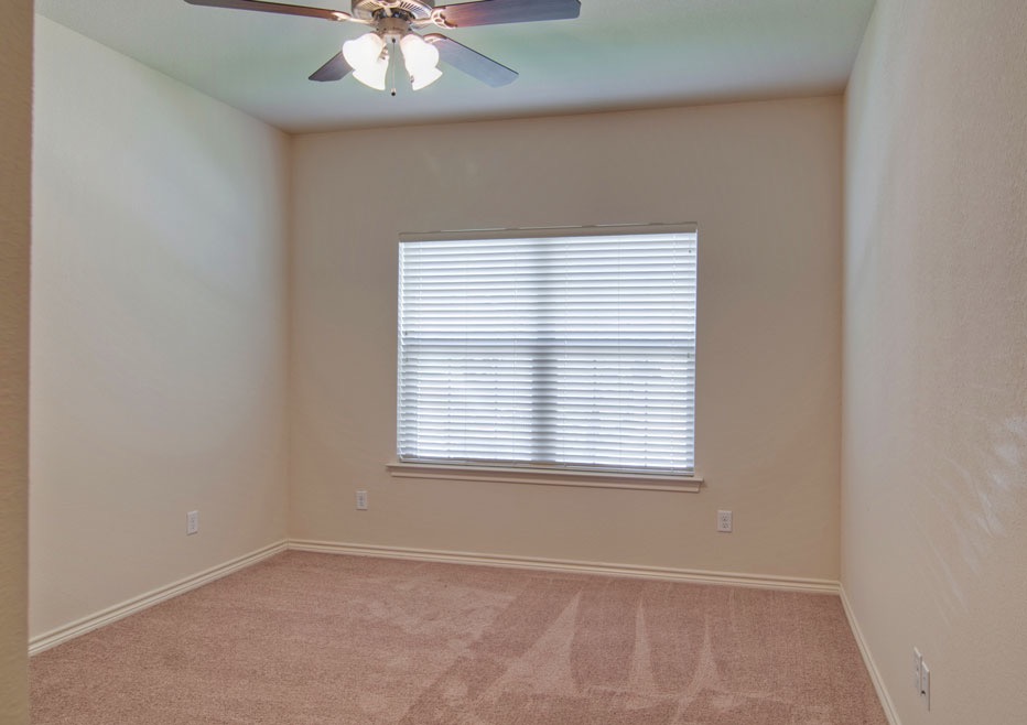 4454 Reveille Road College Station, TX 77845 - Photo 10 of 13 an empty room with a window and a fan