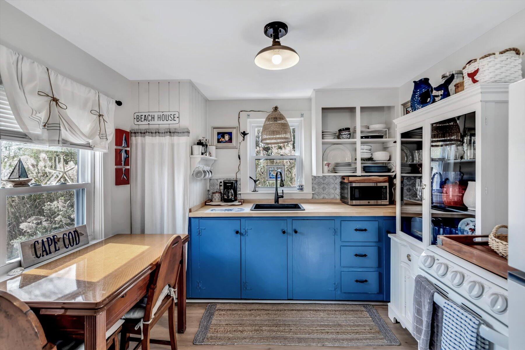 722 State Highway Eastham, MA 02642 - Photo 16 of 31 a kitchen with stainless steel appliances a table and chairs in it