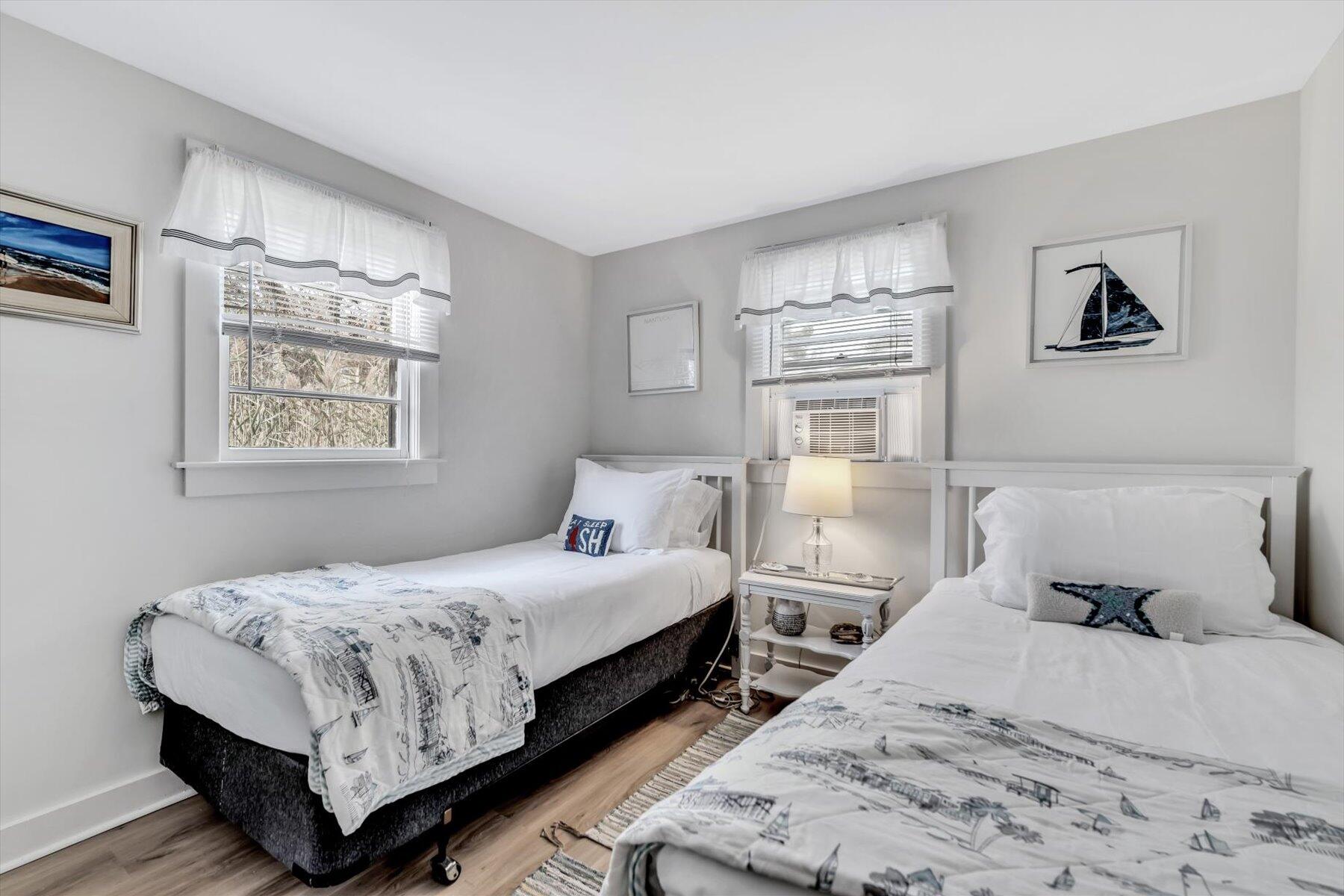 722 State Highway Eastham, MA 02642 - Photo 22 of 31 a bedroom with two bed and painting on the wall