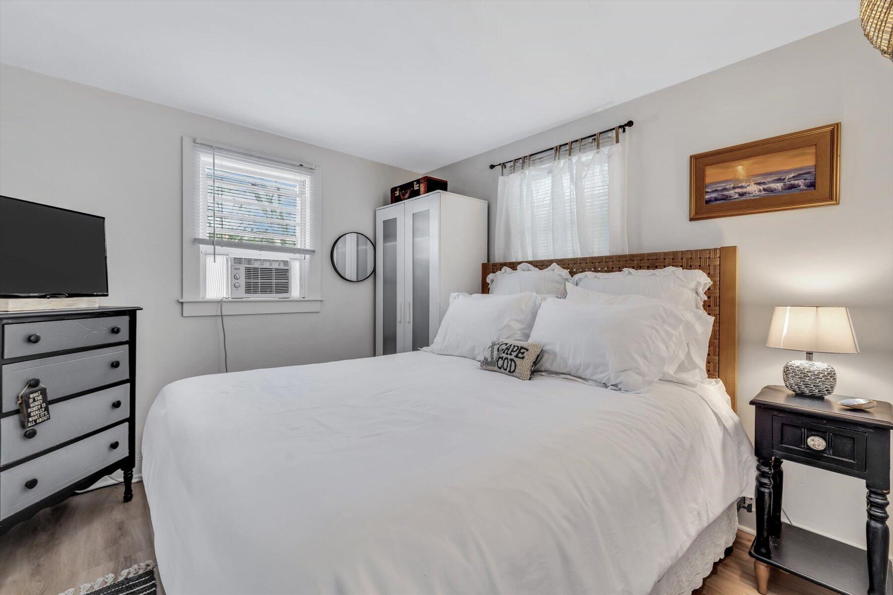 722 State Highway Eastham, MA 02642 - Photo 23 of 31 a bedroom with a bed and a flat tv screen on the dresser