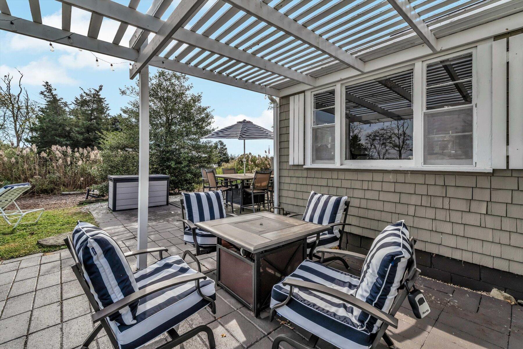 722 State Highway Eastham, MA 02642 - Photo 24 of 31 a view of a patio with a table and chairs