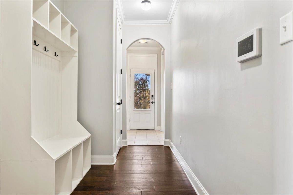 4443 Fleming Road Collierville, TN 38017 - Photo 18 of 40 a view of a hallway to a livingroom with wooden floor and staircase