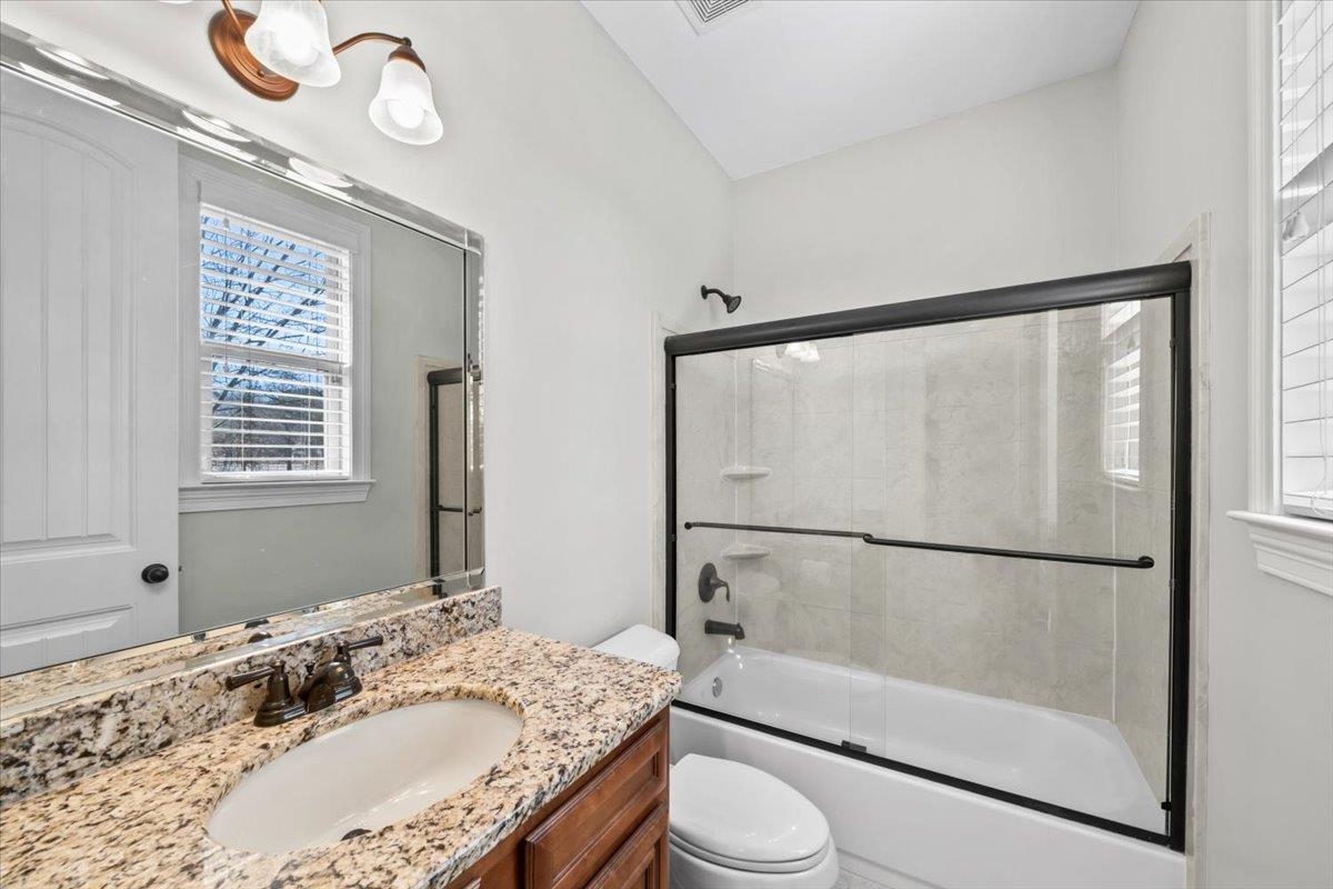 4443 Fleming Road Collierville, TN 38017 - Photo 25 of 40 a bathroom with a granite countertop sink mirror vanity and toilet