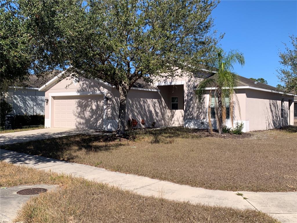 408 Powder View Drive Ruskin, FL 33570 - Photo 3 of 9 a front view of a house with a yard and garage