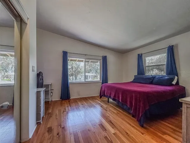 a bed sitting in a bedroom next to a window
