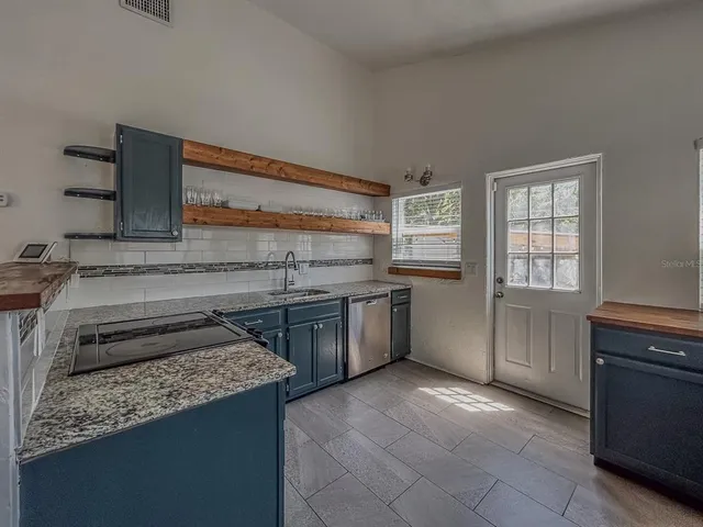 a kitchen with a stove and a sink