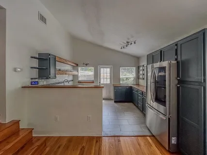 a kitchen with stainless steel appliances a refrigerator and a stove top oven