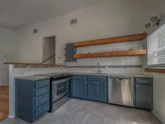 a kitchen with a sink and a stove