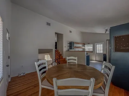 a view of a dining room with furniture and wooden floor