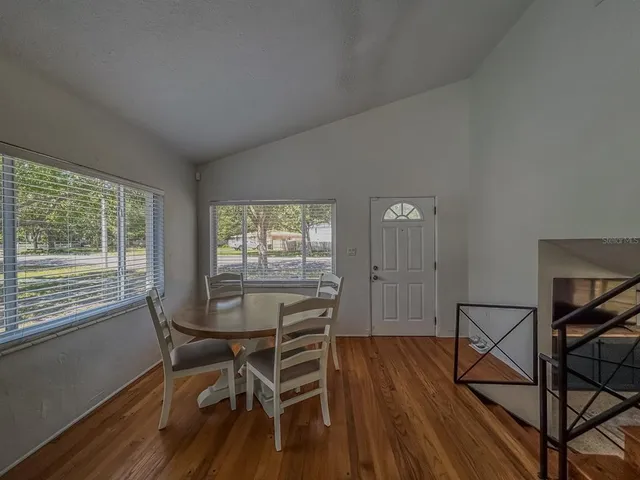a view of a dining room with furniture and wooden floor