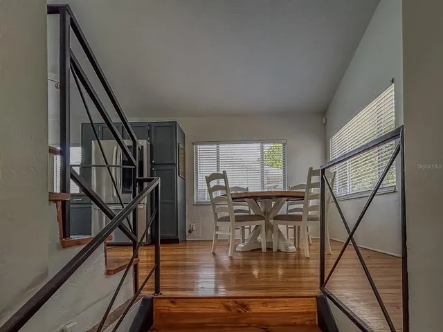 a view of entryway dining room and hall with wooden floor