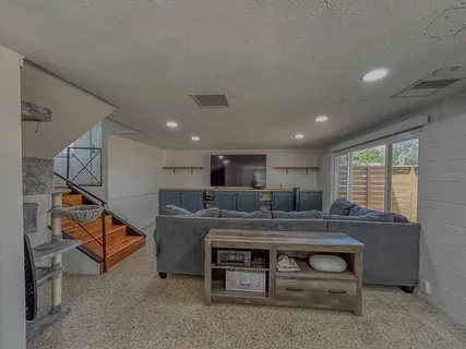 a room with a table chairs and a couch