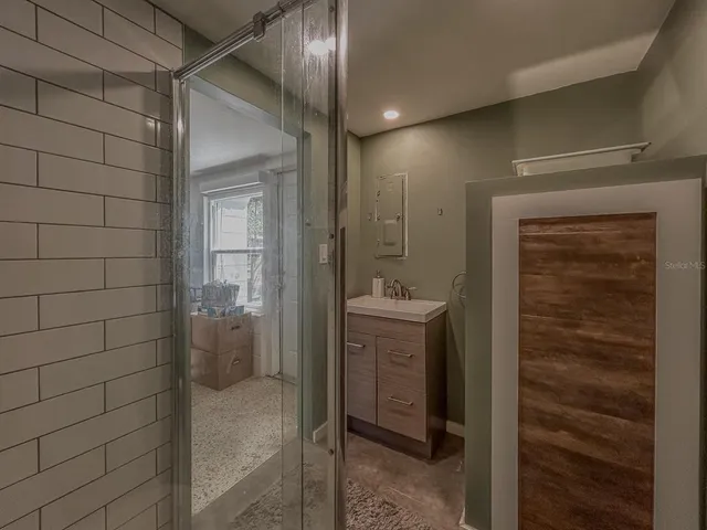 a bathroom with a granite countertop sink toilet and shower