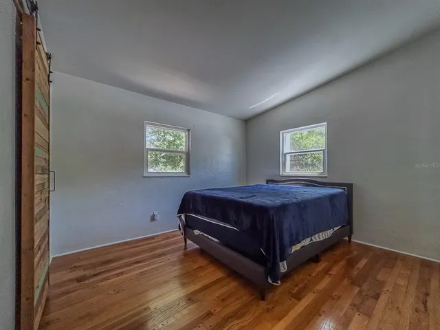 a spacious bedroom with a bed and a window