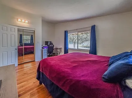 a bed room with a bed and a large window