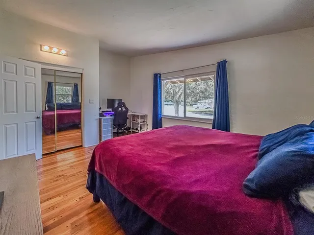 a bed room with a bed and a large window