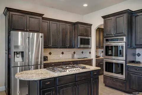 a kitchen with stainless steel appliances and wooden cabinets