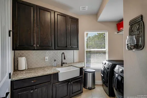 a kitchen with a sink and cabinets