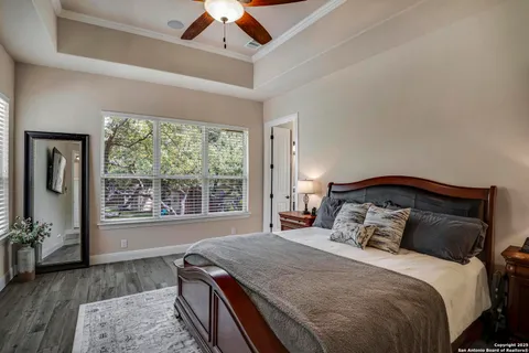 a bedroom with a large bed and a window