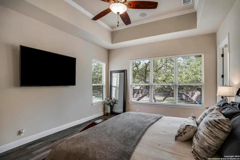 a bedroom with a large bed and a flat screen tv