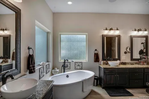 a bathroom with a double vanity sink and a mirror