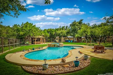 a view of a swimming pool with a yard