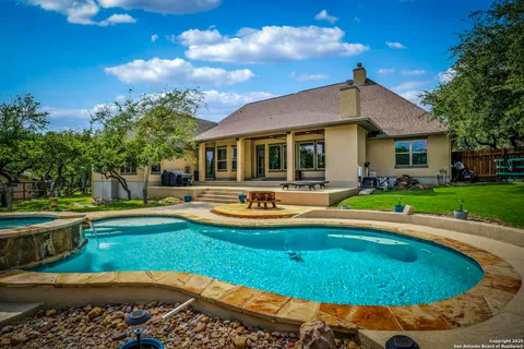 a view of a house with swimming pool and yard with green space