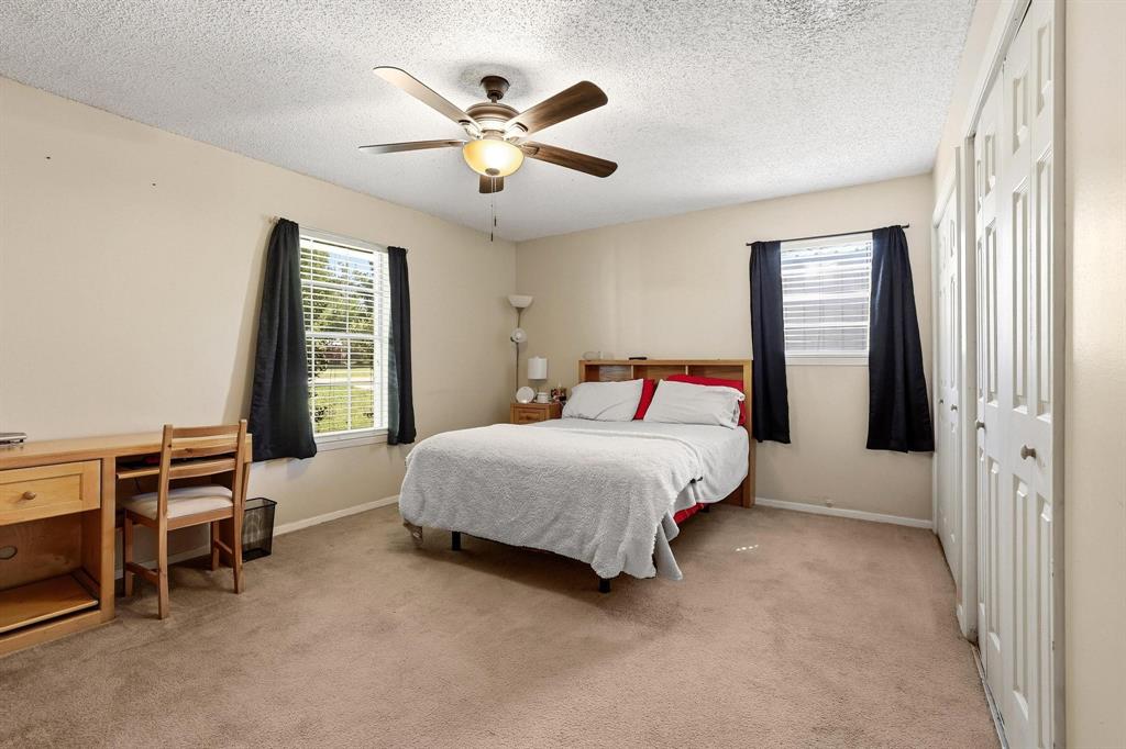 10 Carter Road Van Alstyne, TX 75495 - Photo 2 of 9 a bedroom with a bed and a chandelier